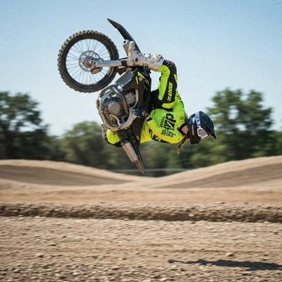 Close-up of a motorcycle rider performing a shoulder head check on a quiet road